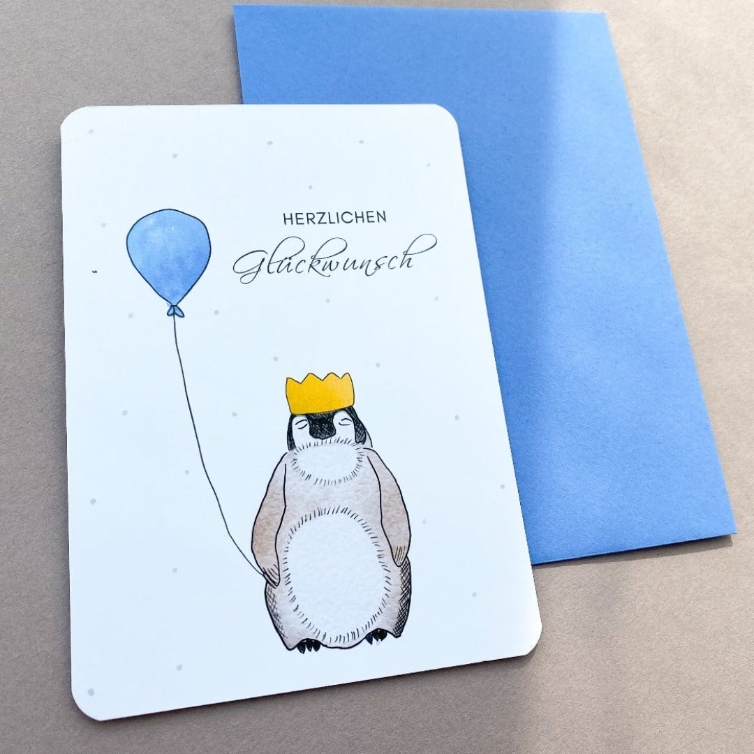 Geburtstagskarte mit Pinguin der 2 blaue Luftballons hält
