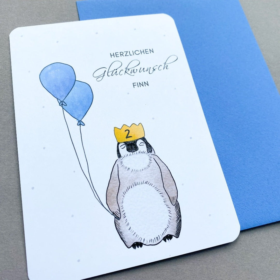 Glückwunschkarte zum Geburtstag mit Pinguin und blauen Luftballons
